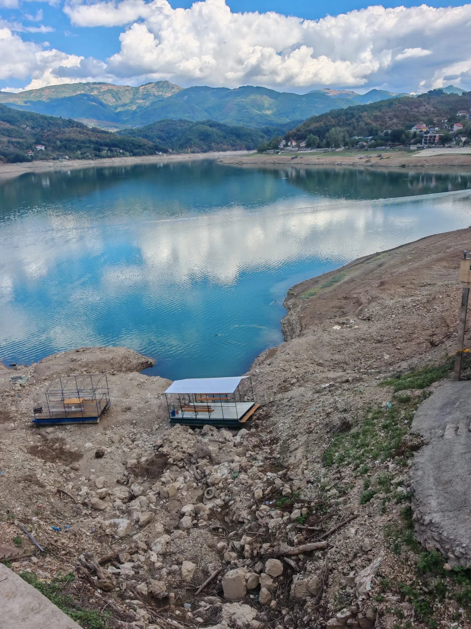 Jablanica Lake, with still turquoise water reflecting the clouds