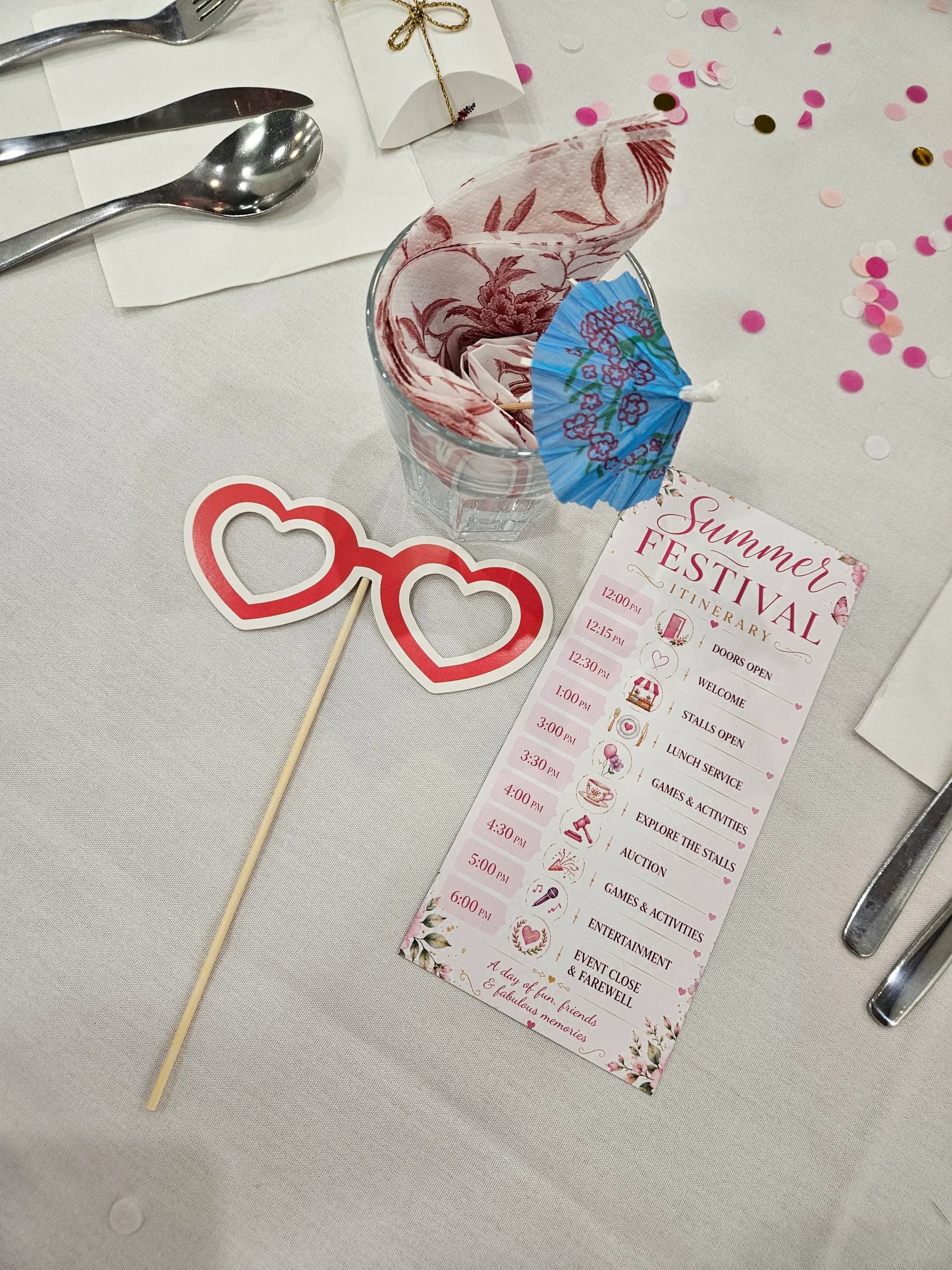 Heart-shaped glasses and the festival programme on a table