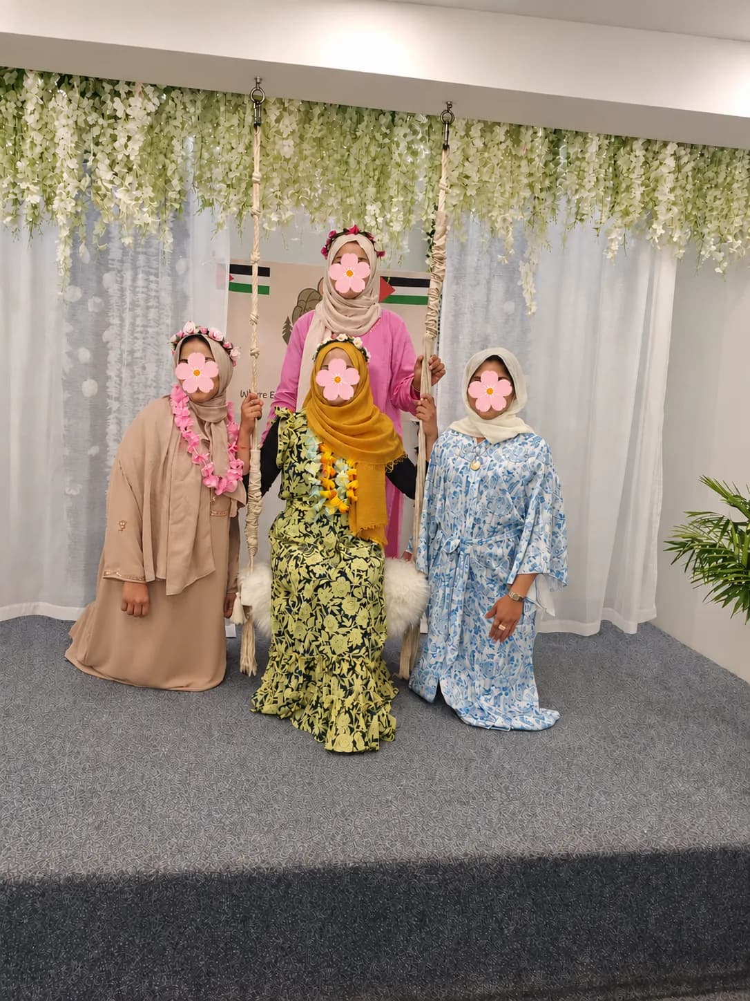Guests posing on the flower swing in the photo booth