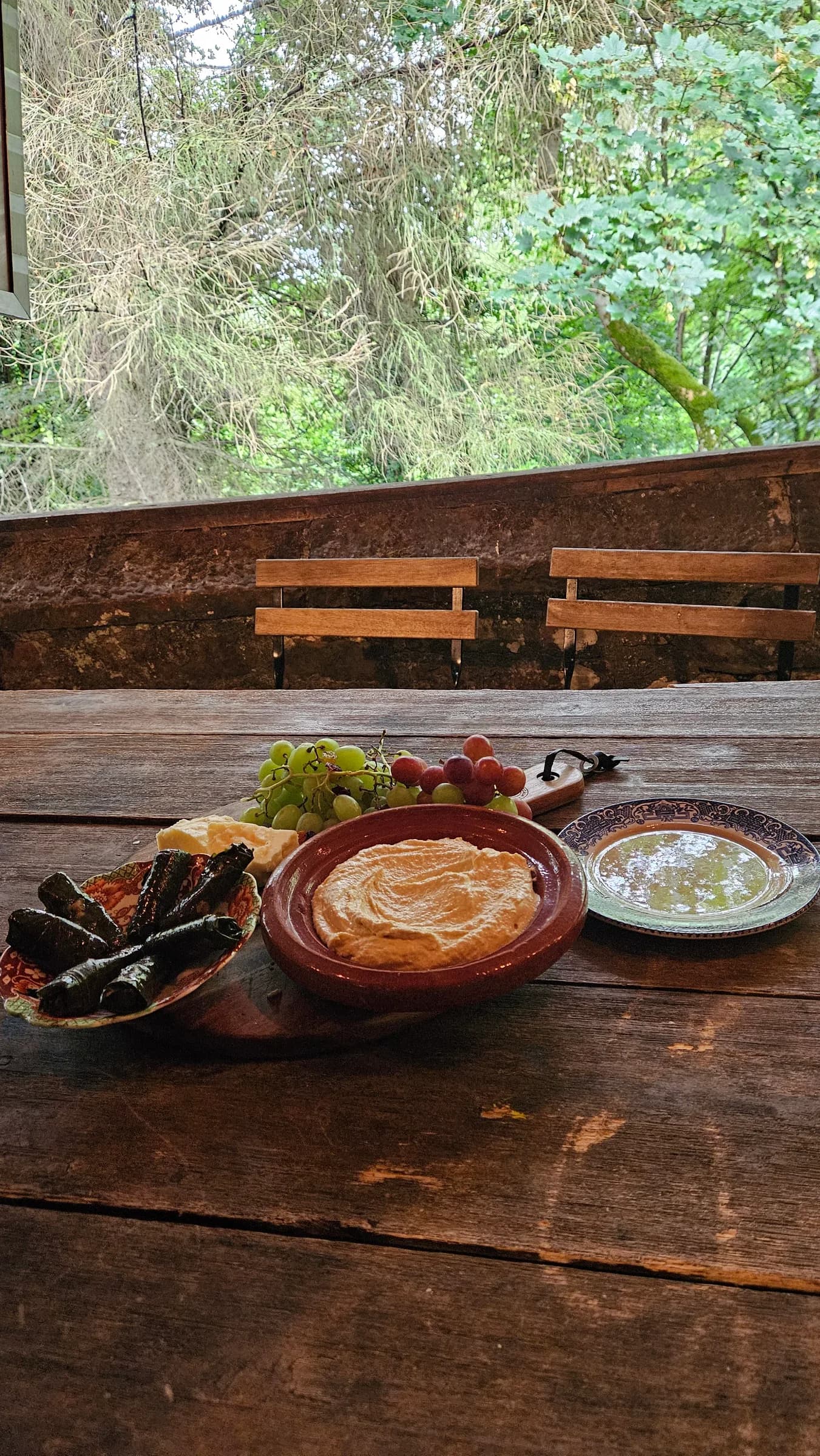 Breakfast laid out on a wooden table outdoors