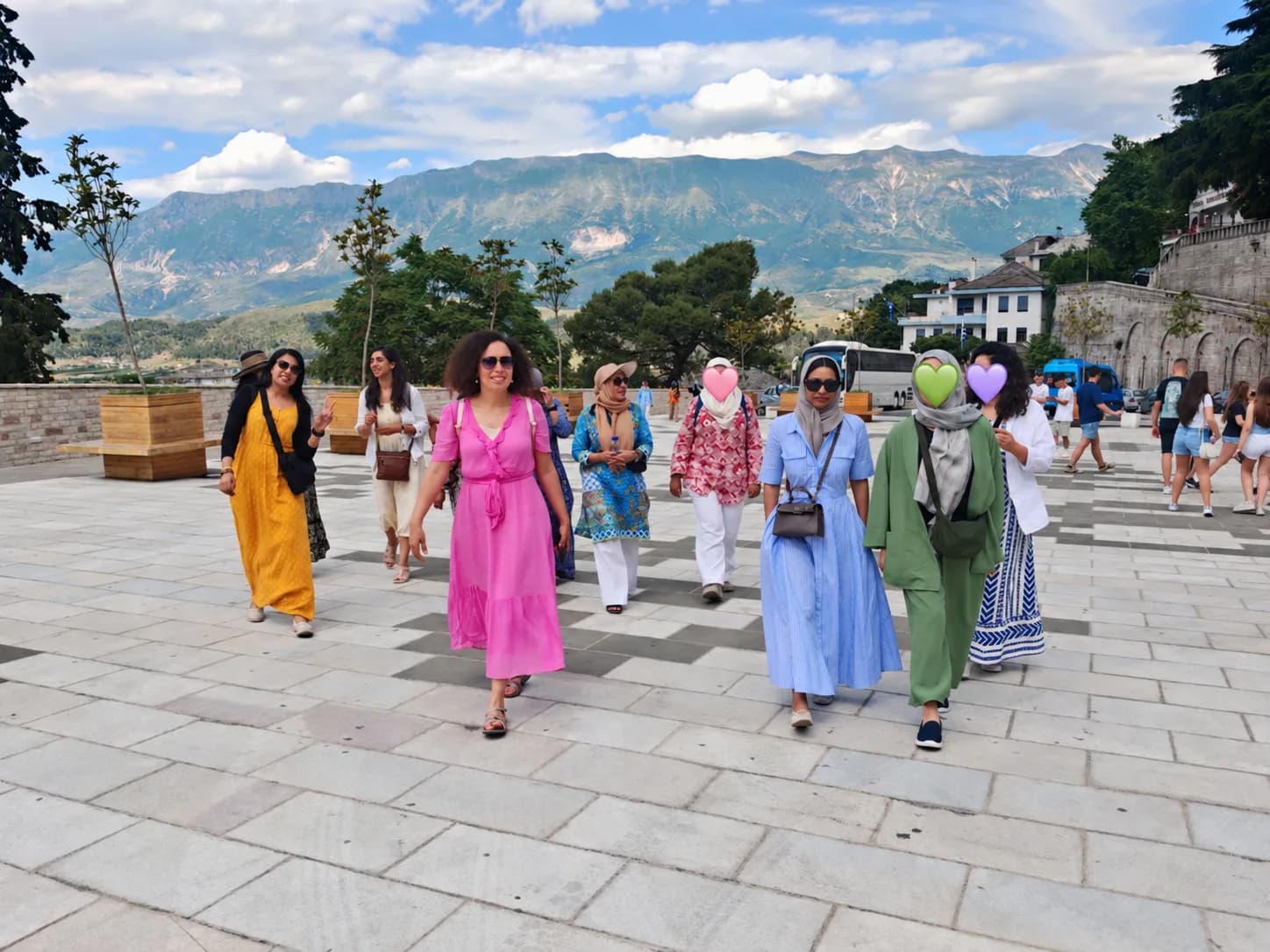 The group walking across a square with mountains behind