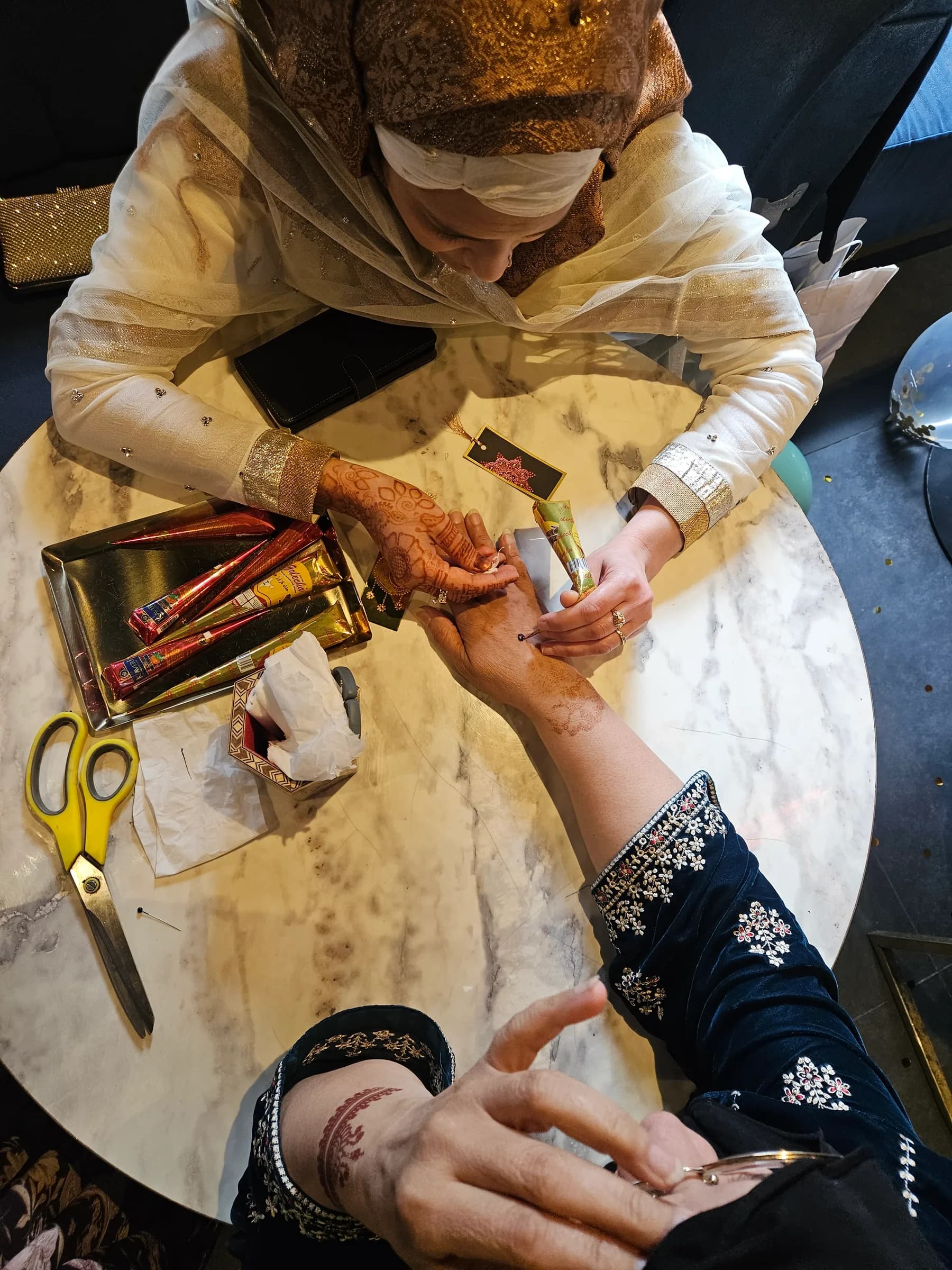 Henna being applied to a guest's hand