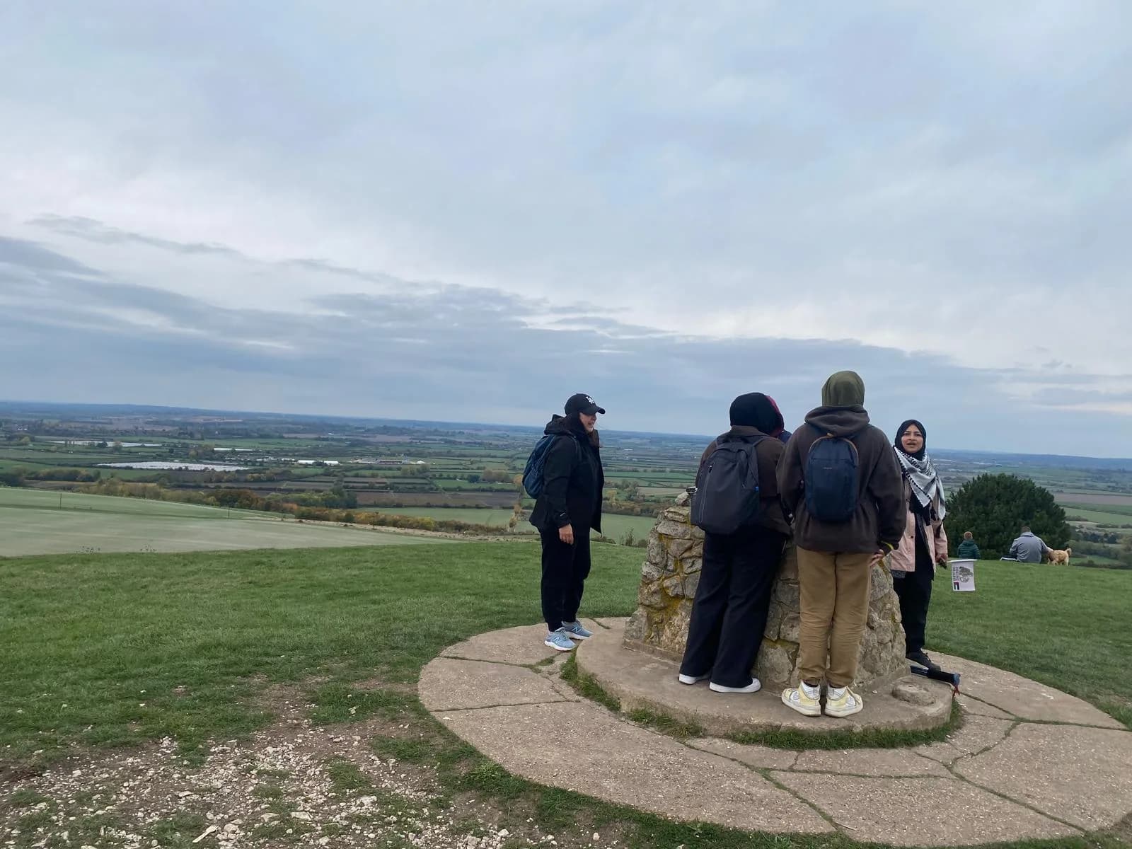 Sisters at a hilltop viewpoint marker