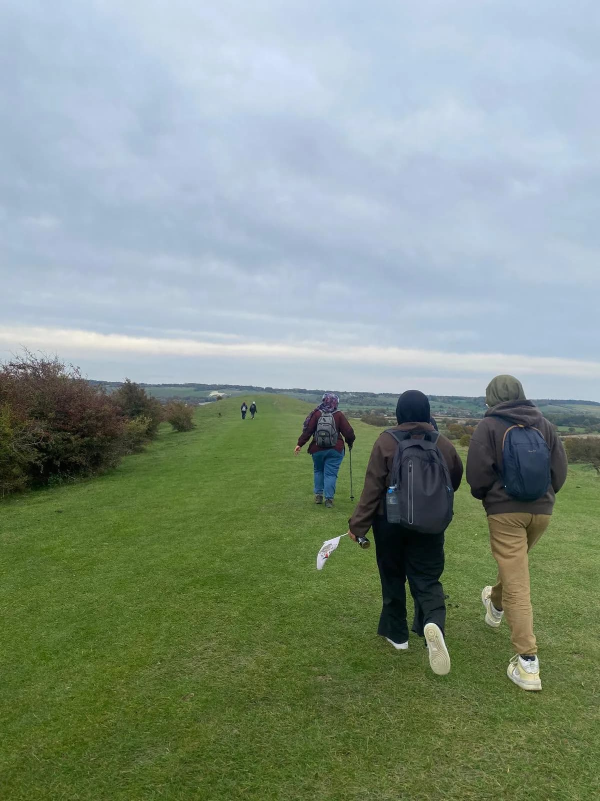 Walking across a grassy hilltop