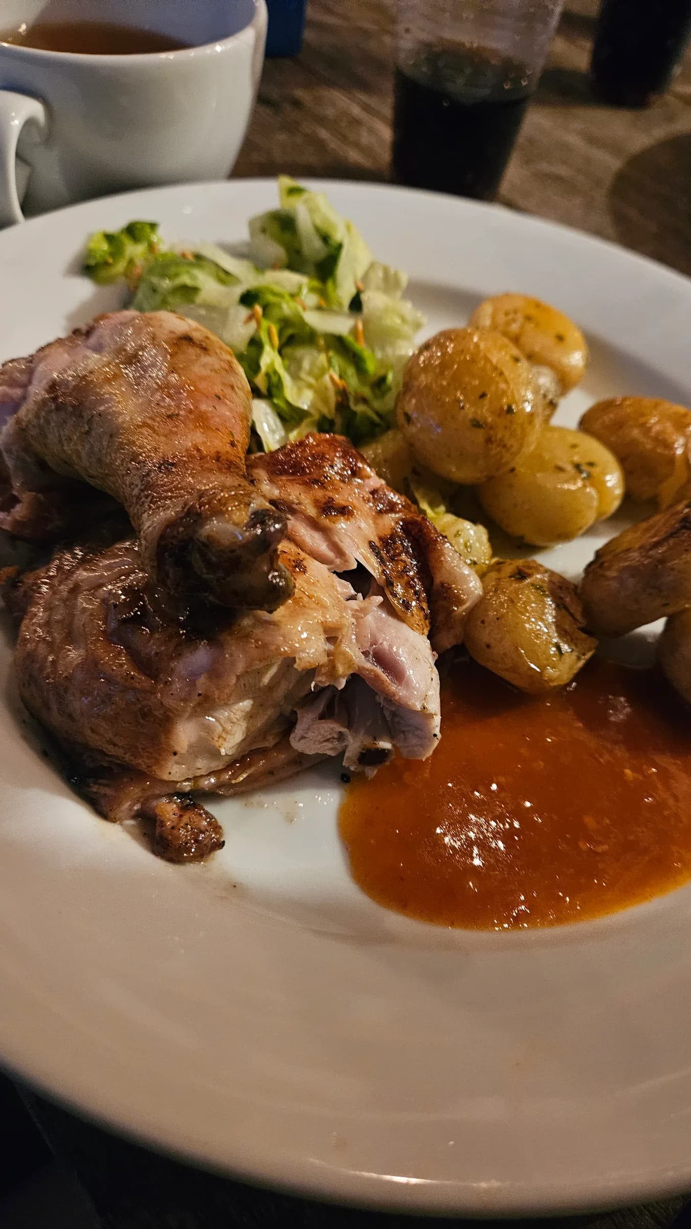 A plate of roast chicken and potatoes