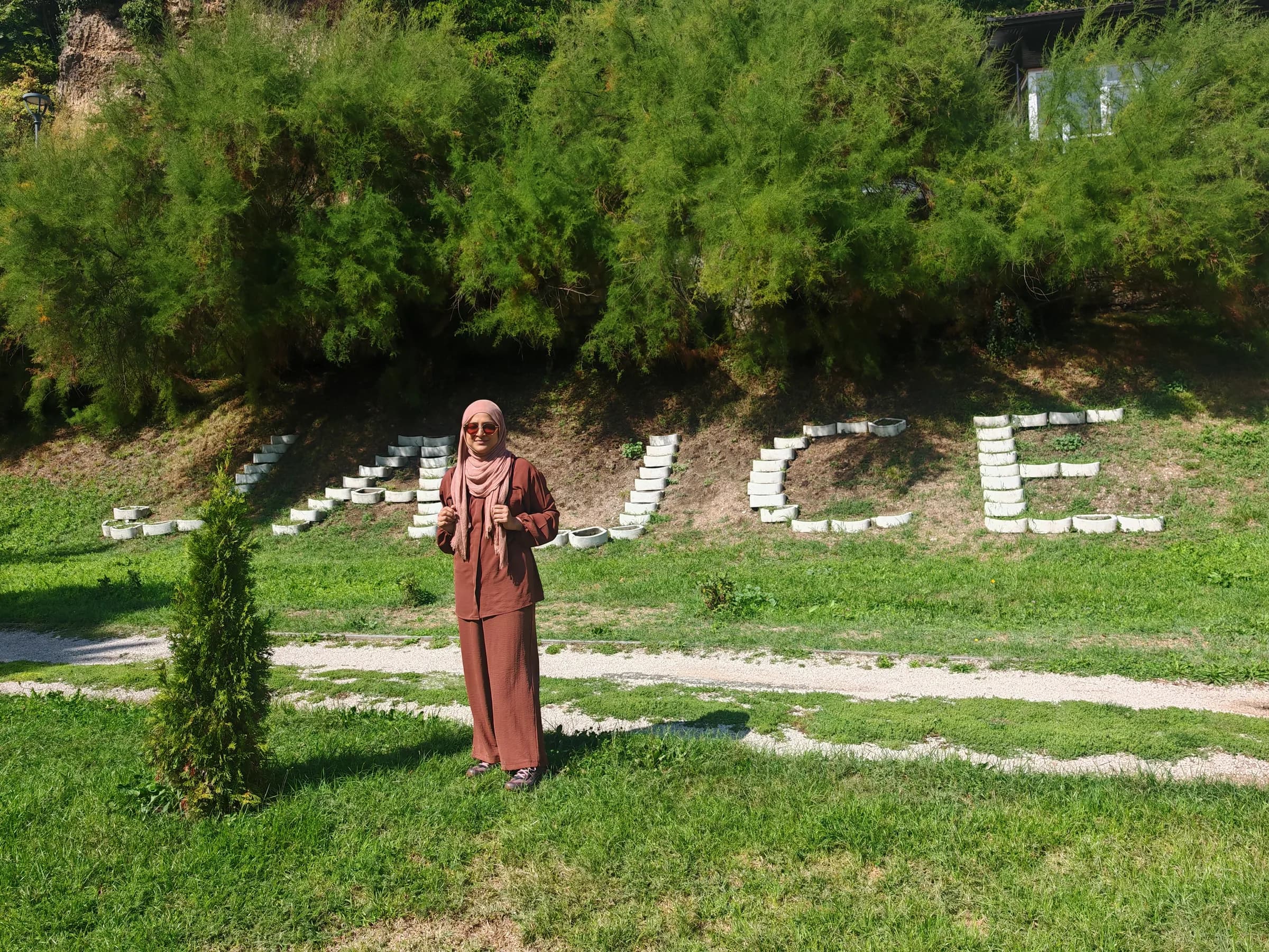 A sister standing in a garden in Jajce