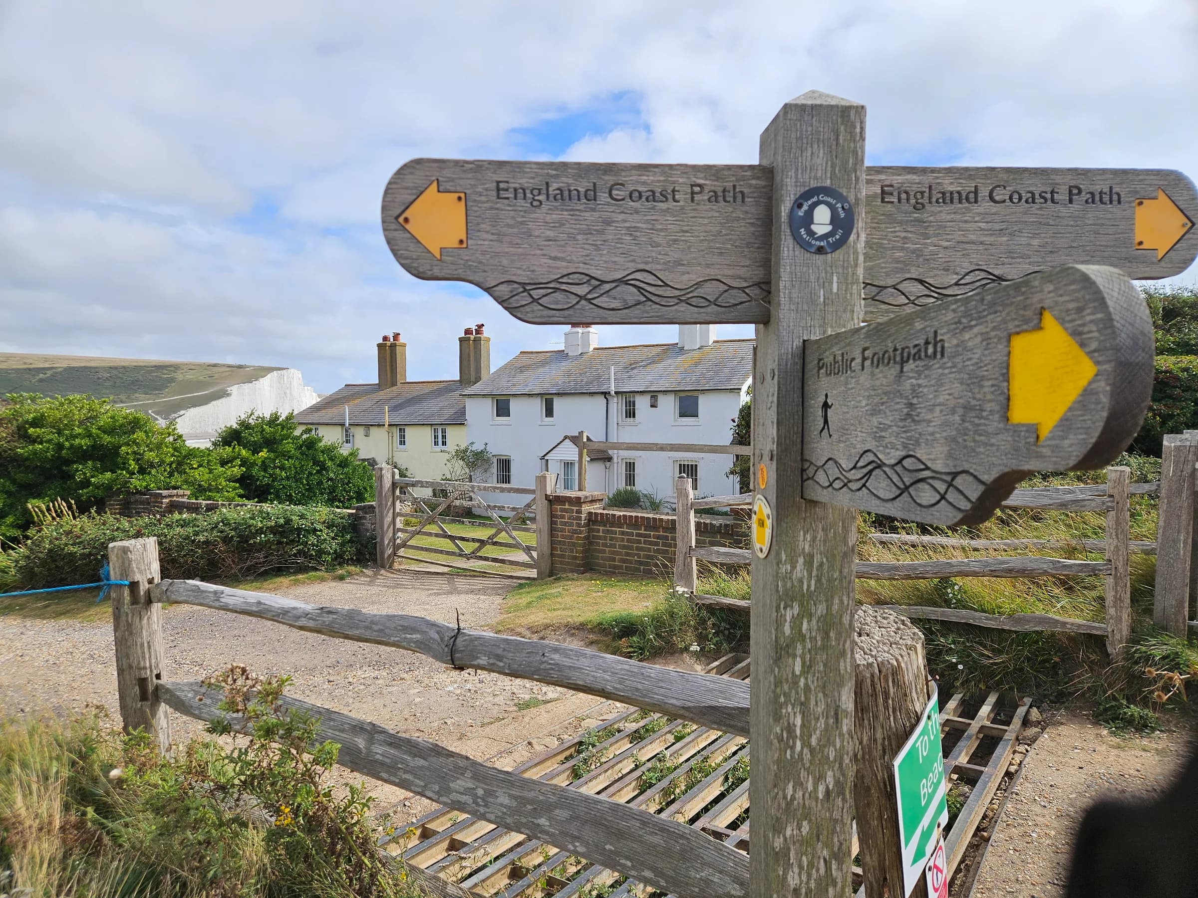 An England Coast Path signpost by the coastguard cottages