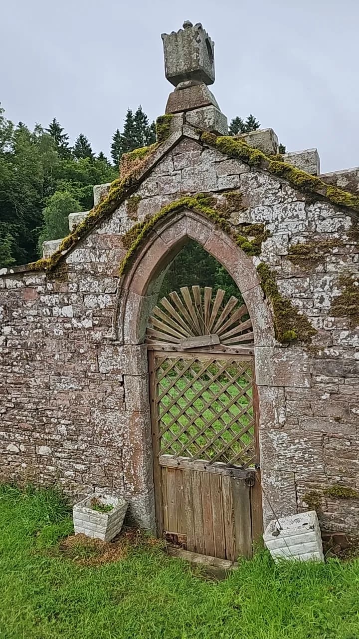 A stone archway with a carved wooden door