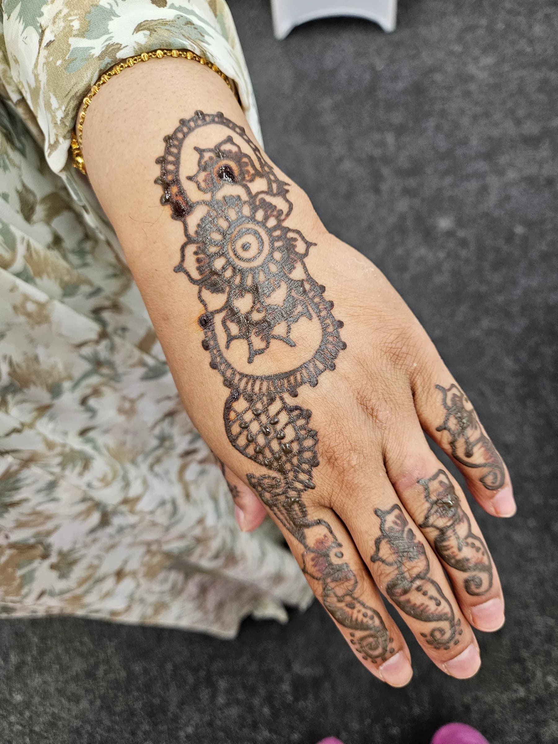 A henna design on a guest's hand