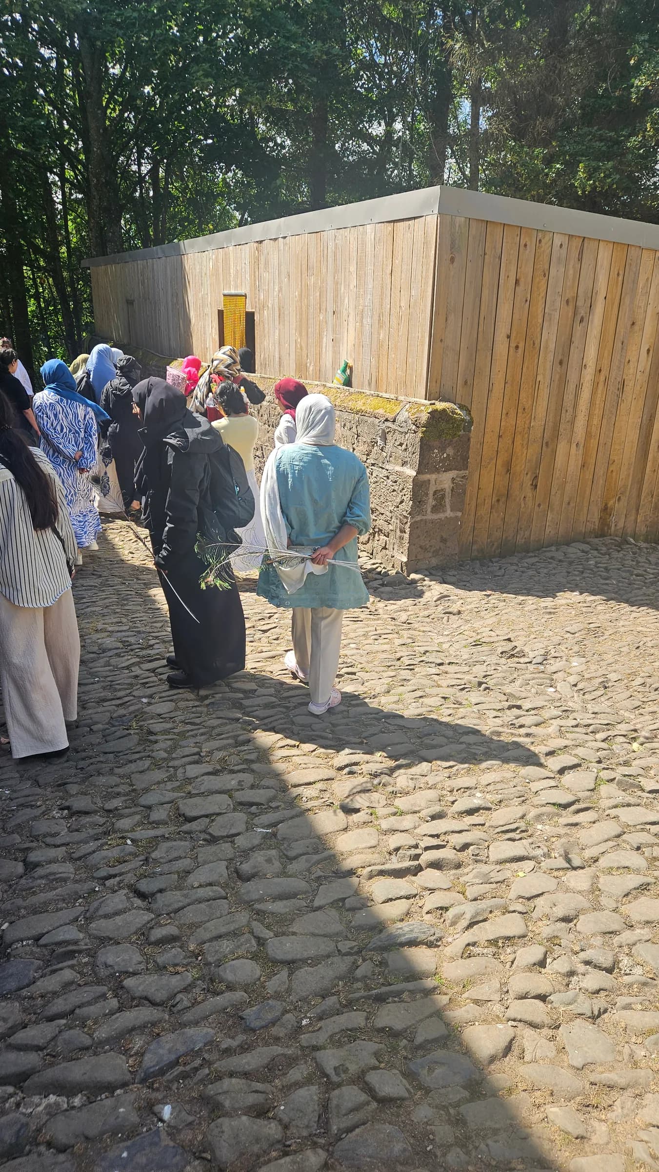 The group arriving along a cobbled courtyard