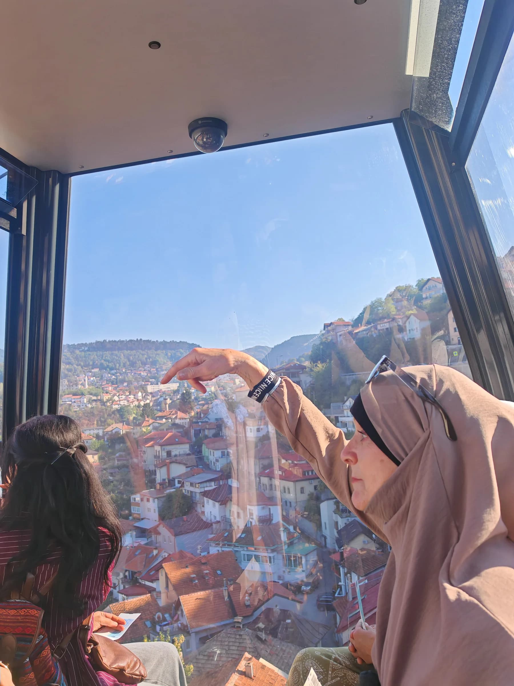 Sisters looking down over Sarajevo from the cable car