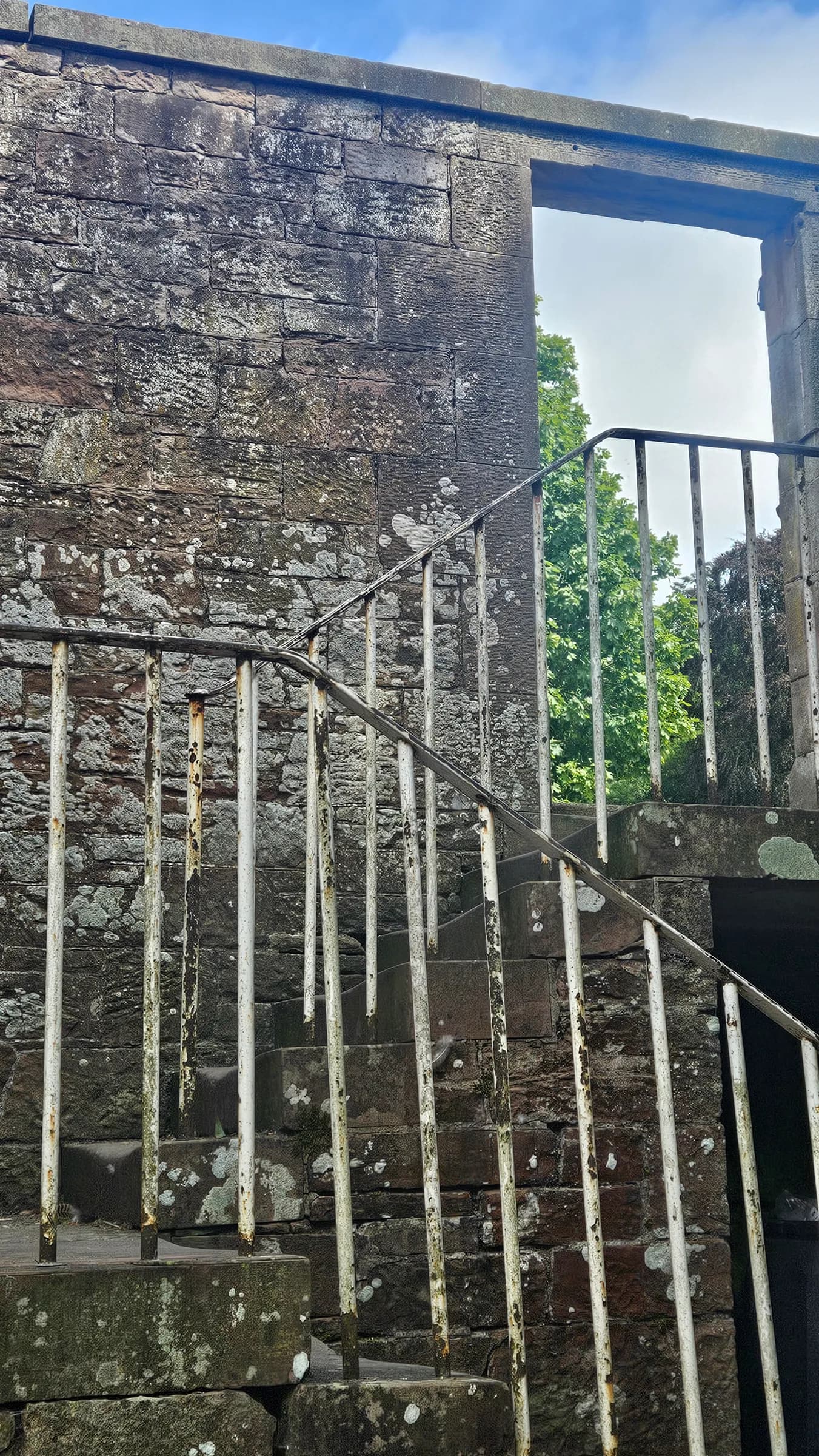 A stone staircase with white railings at the retreat
