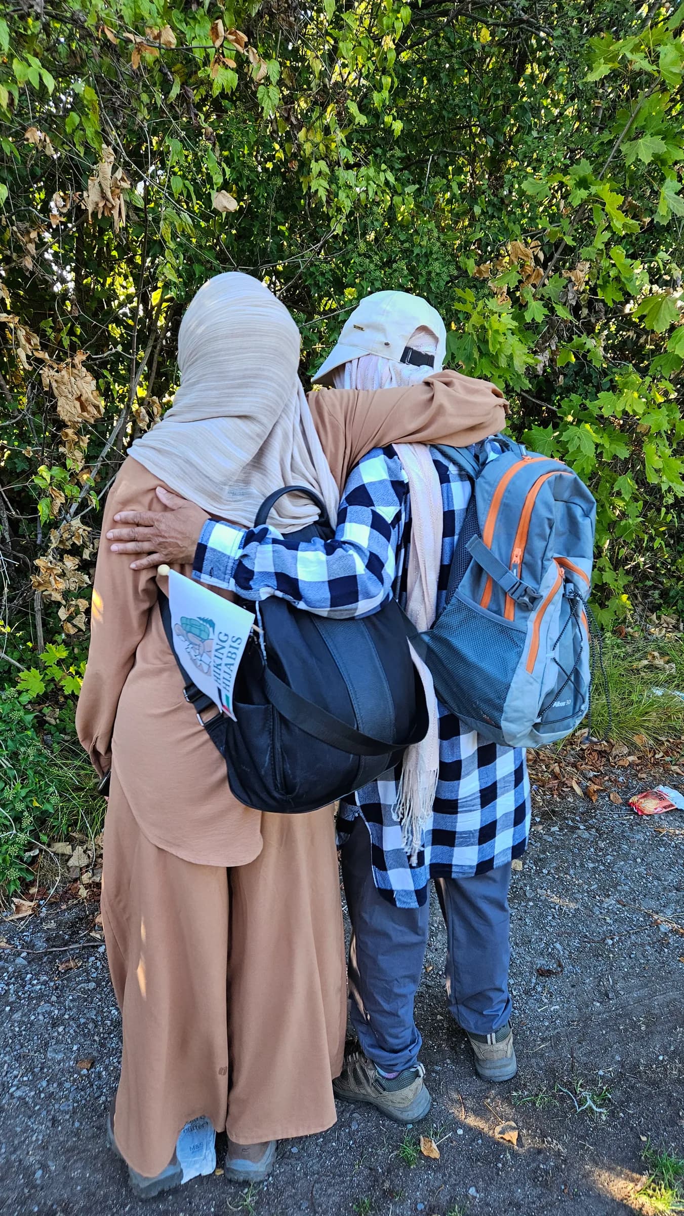 Two sisters sharing a hug at the end of a hike