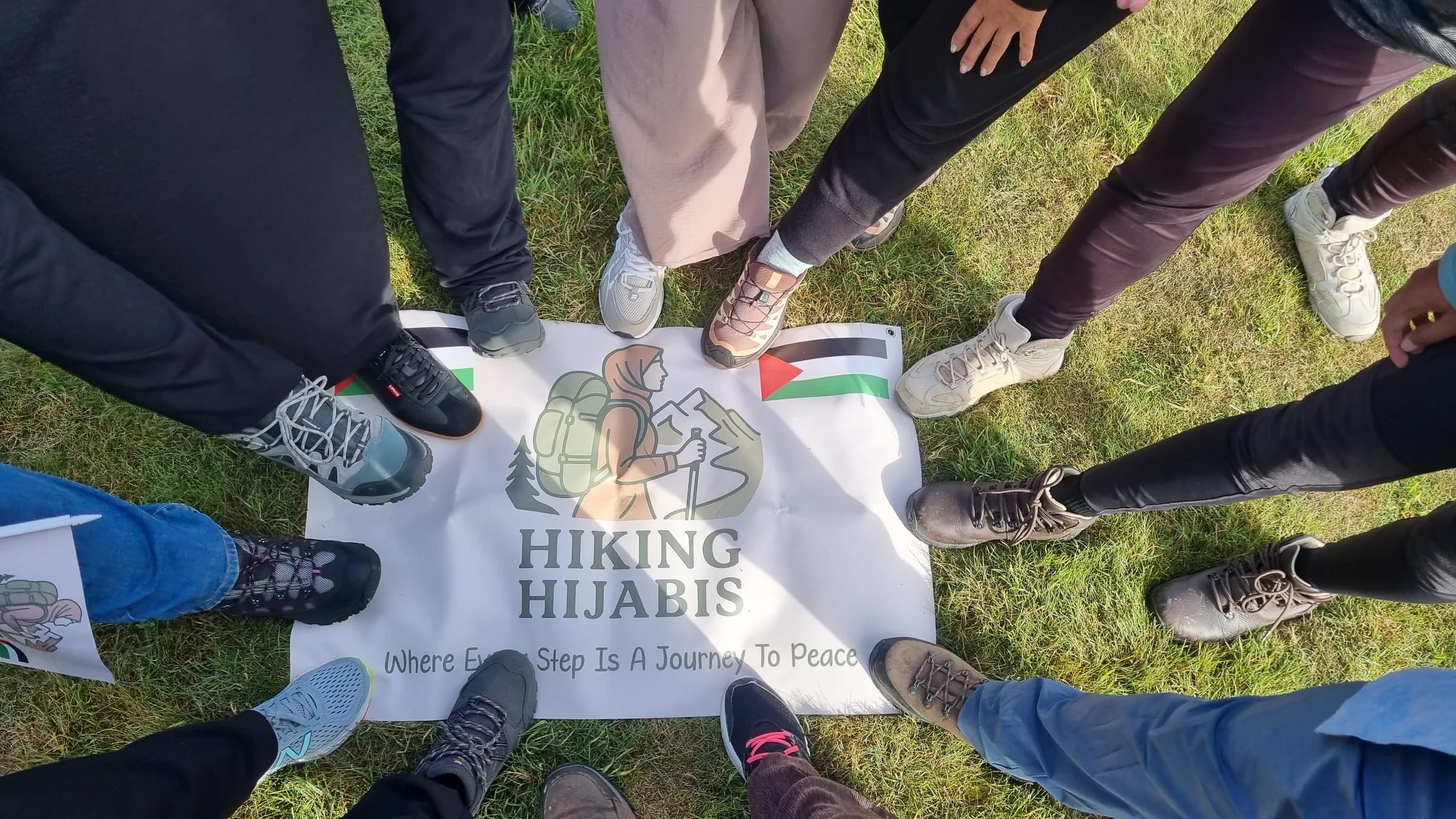 Hiking boots in a circle around the Hiking Hijabis banner