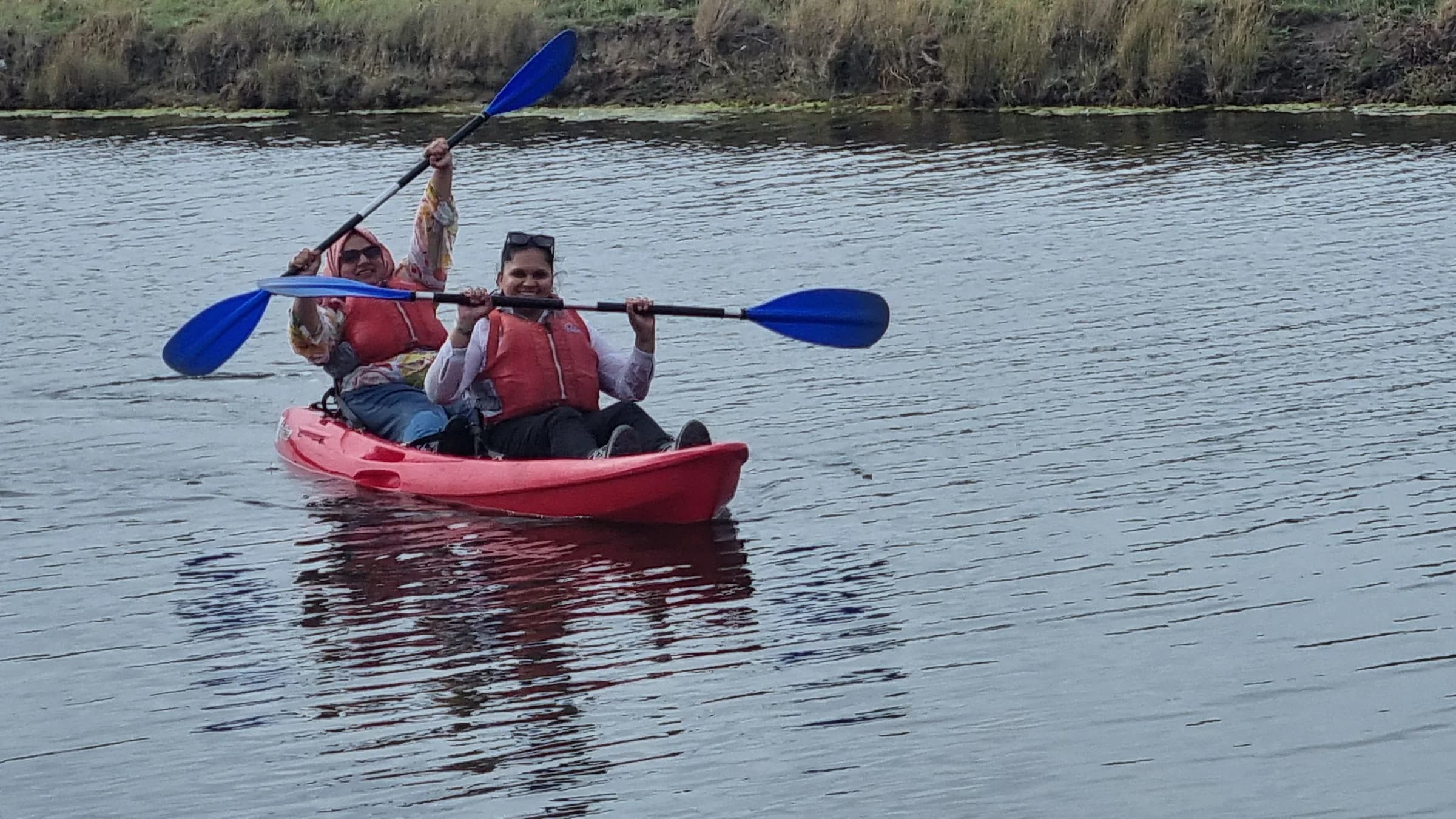 Two sisters kayaking on the river