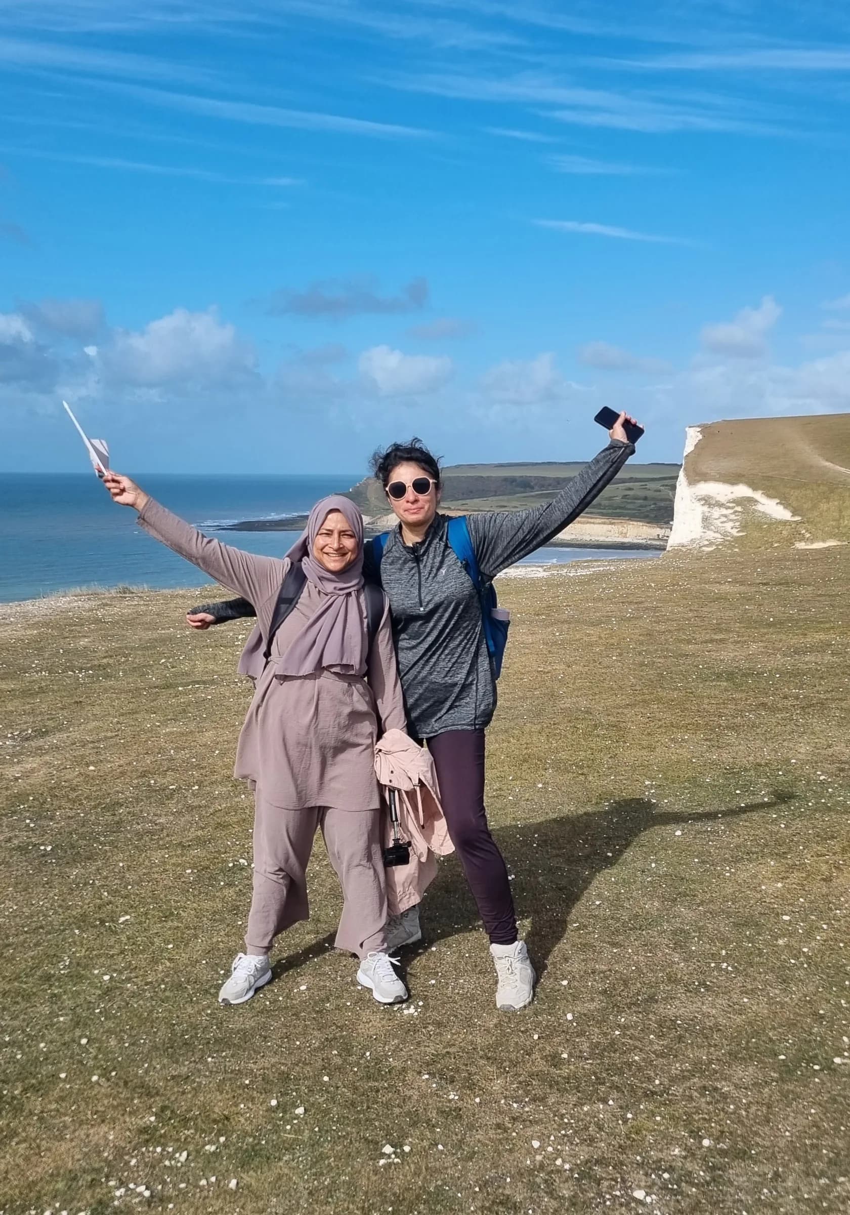 Two sisters celebrating on the cliffs above Cuckmere Haven