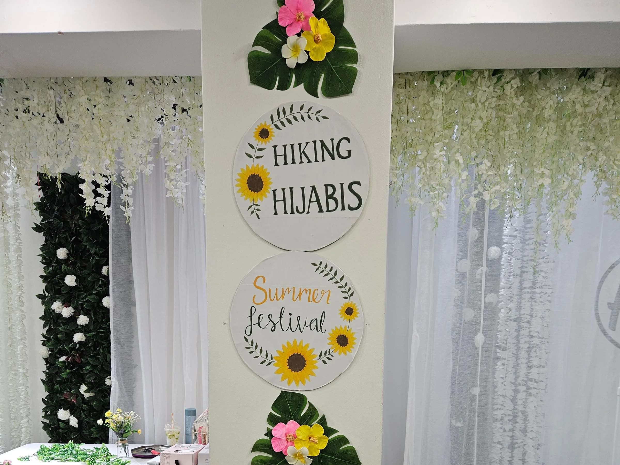 Hiking Hijabis Summer Festival signs and flowers