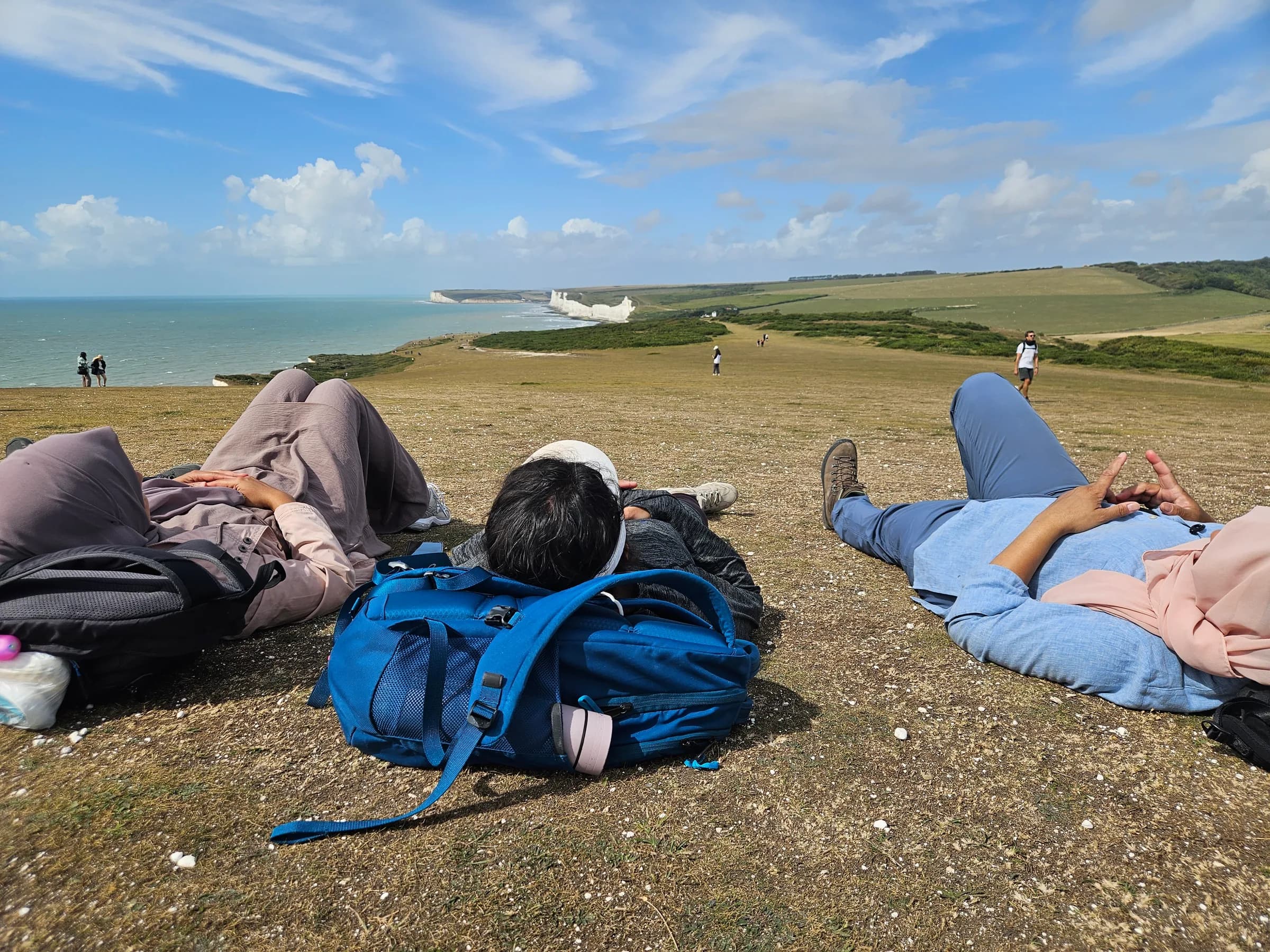 Sisters resting on the grass after a morning hike